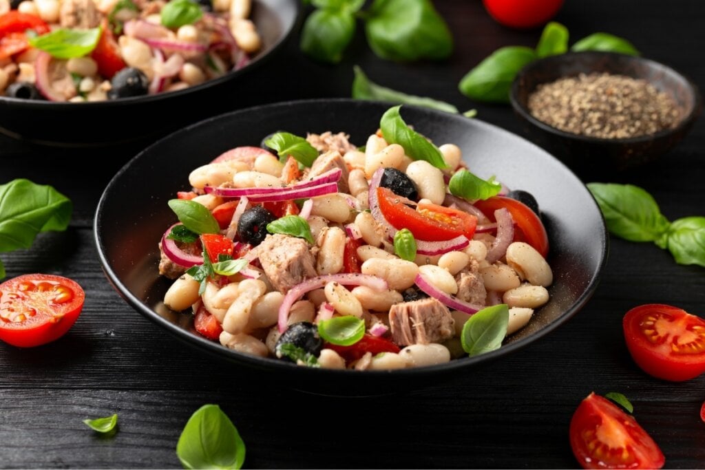 Prato preto com salada de feijão-branco com atum